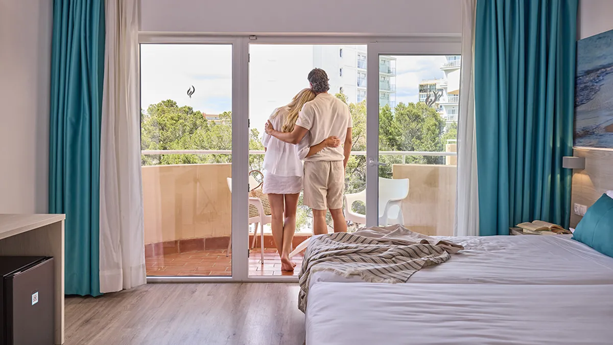 Couple hugging on the balcony at Welikehotel Fenix
