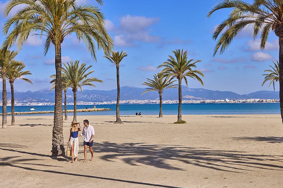 Couple walking on the beach near Welikehotel Fenix